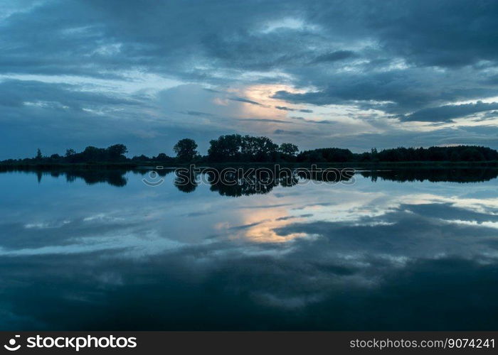 Picturesque clouds reflecting in the water, evening view, Stankow, Poland