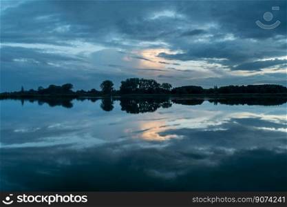 Picturesque clouds reflecting in the water, evening view, Stankow, Poland