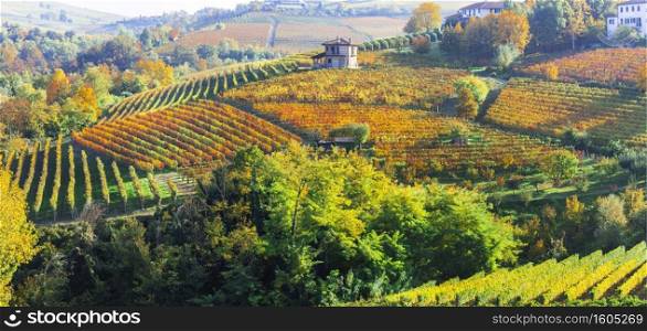 Picturesque countryside of Piedmont with yellow vineyards and small villages. Northern Italy