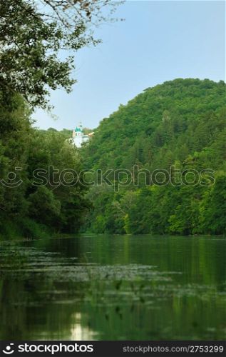 Picturesque forest and the river. Small river at bottom of mountain with mixed by a wood in the East Europe. Ukraine.