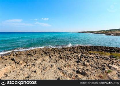 Picturesque Ionian sea beach Punta della Suina, Salento, Puglia, Italy. Gallipoli town view in far.