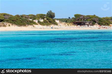 Picturesque Ionian sea Torre Colimena beach, Salento, Puglia, Italy. People unrecognizable.