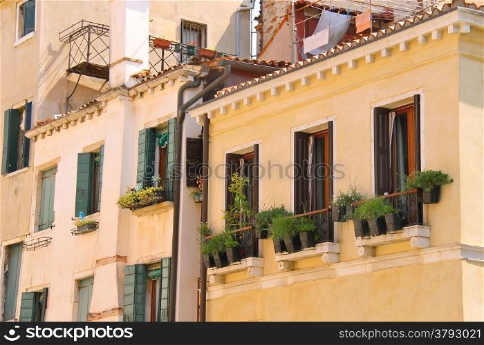 Picturesque Italian house with flowers on the balconie