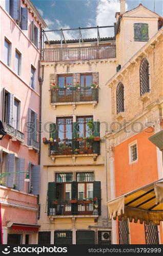 Picturesque Italian house with flowers on the balconies