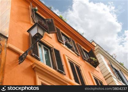 Picturesque Italian house with flowers on the windows