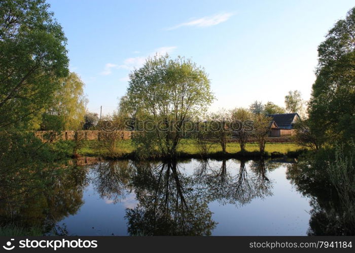 Picturesque lake in the privat possesion. beautiful spring landscape with picturesque lake in privat possesion