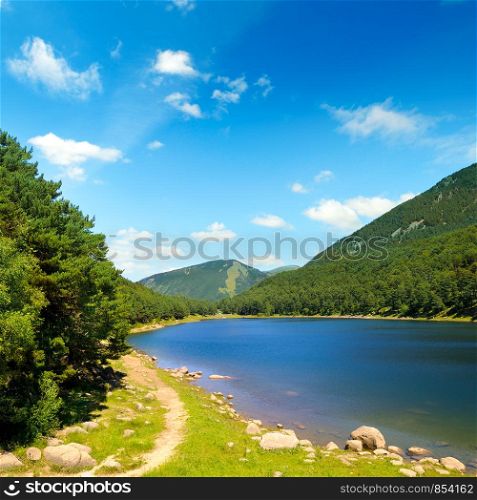Picturesque lake, mountains and blue sky. The concept is travel.