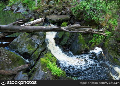 Picturesque landscape with a waterfall in the forest of Karelia, Russia