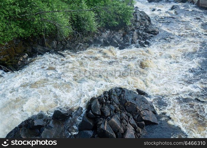 Picturesque landscape with a waterfall in the forest of Karelia, Russia