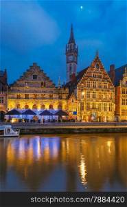 Picturesque medieval building and Clock Tower on the quay Graslei in Leie river at Ghent town at morning, Belgium