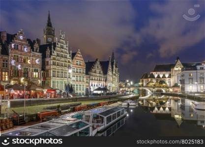 Picturesque medieval building and St Michael&amp;#39;s Bridge on the quay Graslei in Leie river at Ghent town at night, Belgium