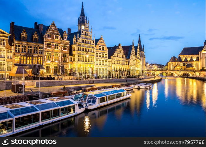 Picturesque medieval buildings on Leie river in Ghent town, Belgium at dusk.