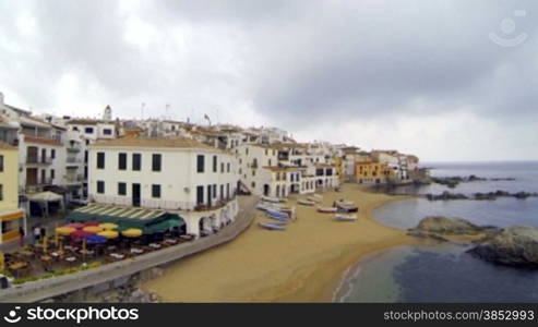 Picturesque Mediterranean fishing village in la Costa Brava, Girona.Aerial drone shot flying over the rooftops to the old center of Calella de Palafrugell.Flying over turquoise beaches with a DJI Phantom multicopter, a GoPro Hero 3 black Edition and