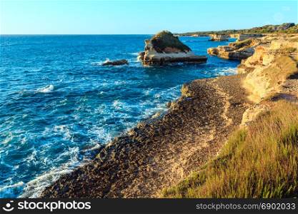 Picturesque morning sunrise seascape with white rocky cliffs, sea bay and islets at Grotta dello Mbruficu, Salento Adriatic sea coast, Puglia, Italy