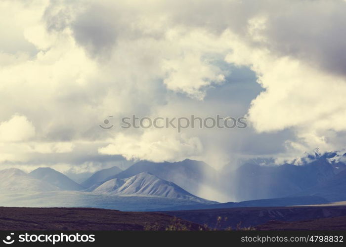 Picturesque Mountains of Alaska in summer. Snow covered massifs, glaciers and rocky peaks.