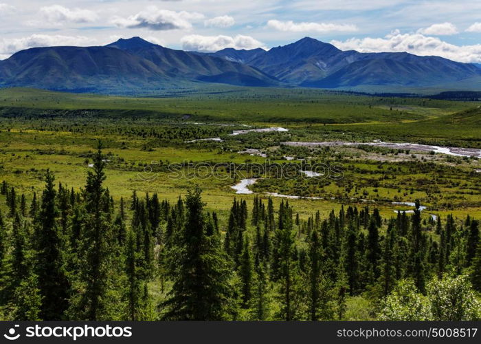 Picturesque Mountains of Alaska in summer. Snow covered massifs, glaciers and rocky peaks.