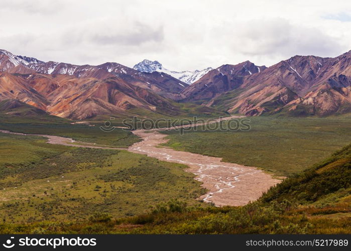 Picturesque Mountains of Alaska in summer. Snow covered massifs, glaciers and rocky peaks.