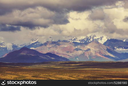 Picturesque Mountains of Alaska in summer. Snow covered massifs, glaciers and rocky peaks.