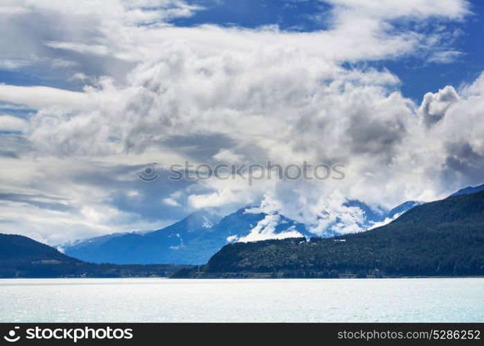 Picturesque Mountains of Alaska in summer. Snow covered massifs, glaciers and rocky peaks.