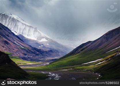 Picturesque Mountains of Alaska in summer. Snow covered massifs, glaciers and rocky peaks.