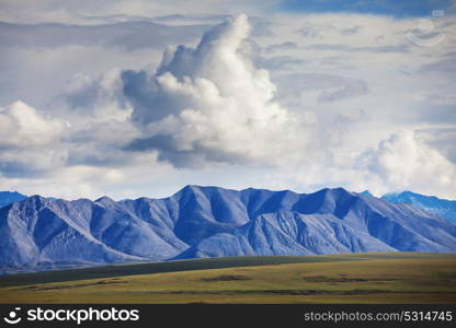 Picturesque Mountains of Alaska in summer. Snow covered massifs, glaciers and rocky peaks.