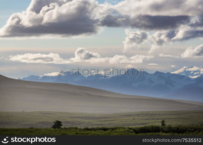 Picturesque Mountains of Alaska in summer. Snow covered massifs, glaciers and rocky peaks.