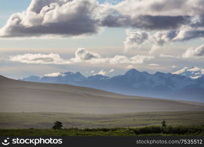 Picturesque Mountains of Alaska in summer. Snow covered massifs, glaciers and rocky peaks.