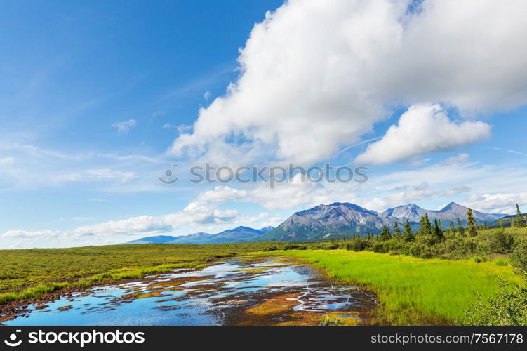 Picturesque Mountains of Alaska in summer. Snow covered massifs, glaciers and rocky peaks.