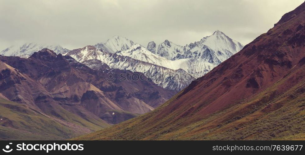 Picturesque Mountains of Alaska in summer. Snow covered massifs, glaciers and rocky peaks.