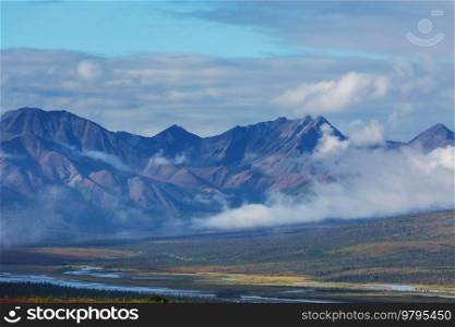 Picturesque Mountains of Alaska in summer. Snow covered massifs, glaciers and rocky peaks. Beautiful natural background.