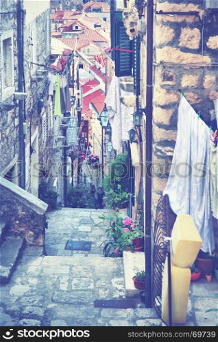 Picturesque old narrow street in Dubrovnik, Croatia. Toned image