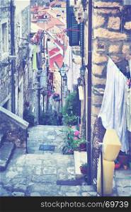 Picturesque old narrow street in Dubrovnik, Croatia. Toned image