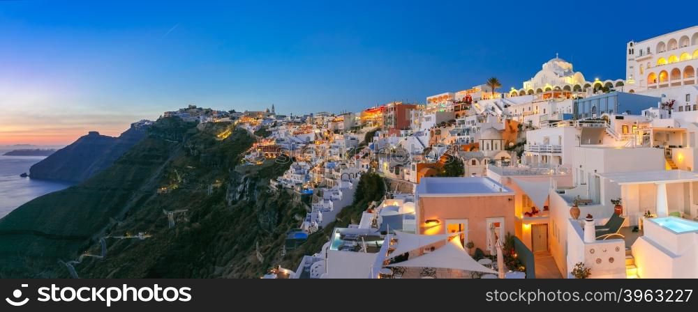 Picturesque panorama of Fira, main town of the island Santorini, sea, white houses and church at sunset, Greece