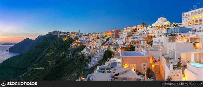 Picturesque panorama of Fira, main town of the island Santorini, sea, white houses and church at sunset, Greece