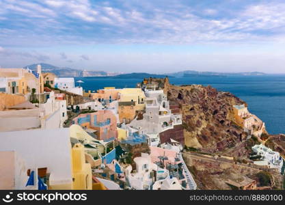 Picturesque panorama of Oia or Ia on the island Santorini, Byzantine Castle Ruins, white houses and church with blue domes, Greece. Panorama Oia or Ia on the island Santorini, Greece