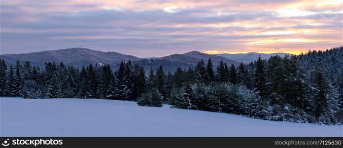 Picturesque panorama of winter mountains and forest at sunrise in the morning (high resolution photomerge panorama).