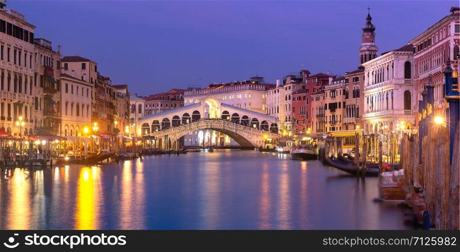 Picturesque panoramic view of famous Rialto Bridge over the Grand Canal in Venice at night, Italy.. The Rialto Bridge, Venice, Italy