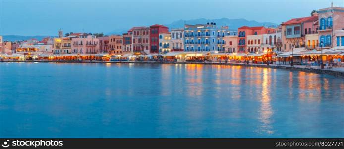 Picturesque panoramic view of old harbour and Venetian quay of Chania during twilight blue hour, Crete, Greece