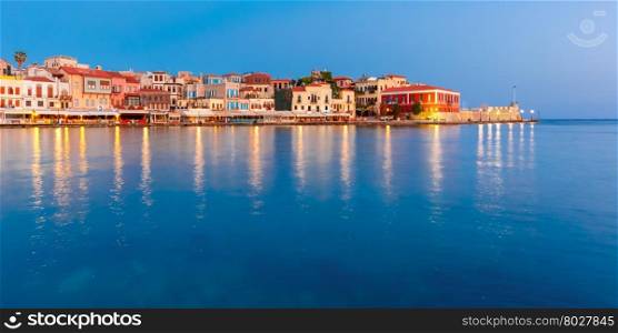 Picturesque panoramic view of old harbour and Venetian quay of Chania during twilight blue hour, Crete, Greece