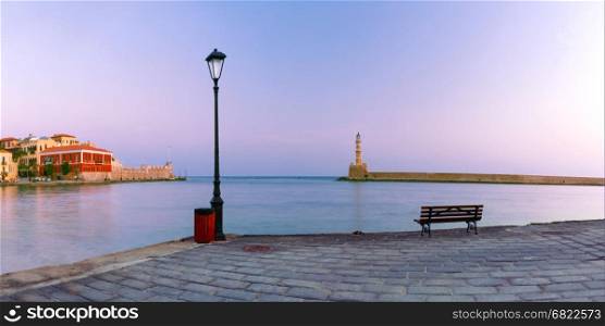 Picturesque panoramic view of old harbour with Lighthouse of Chania during morning blue hour, Crete, Greece