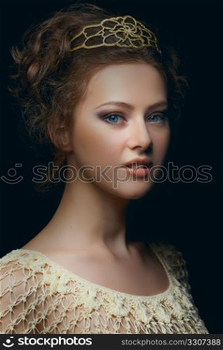 Picturesque portrait of majestic young woman with blue eyes in low key