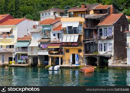 Picturesque residential houses in tranquil scenery of Anadolu Kavagi village waterfront in Turkey at the end of the Bosporus Strait