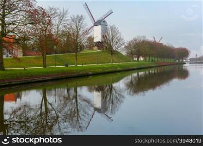 Picturesque rural landscape with Bonne Chiere Windmill and canal in Bruges, Belgium