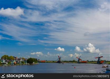 Picturesque rural landscape with windmills in Zaanse Schans close to river, Holland, Netherlands