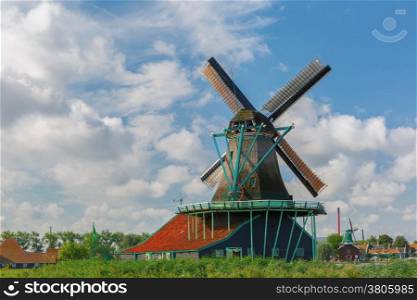 Picturesque rural landscape with windmills in Zaanse Schans close to river, Holland, Netherlands