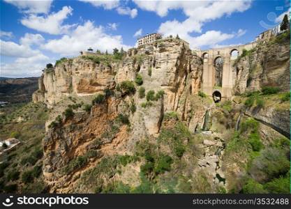 Picturesque scenery in Andalucia region of Spain, rock formation and the New Bridge in Ronda, Malaga province, Spain.