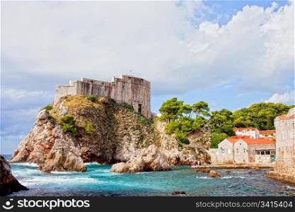 Picturesque scenery of a small bay on the Adriatic Sea and fort Lovrijenac medieval landmark in Dubrovnik, Croatia, Dalmatia County