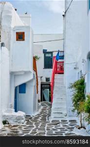 Picturesque scenic narrow Greek streets with traditional whitewashed houses with blue doors windows of Mykonos town in famous tourist attraction Mykonos island, Greece. Greek Mykonos street on Mykonos island, Greece