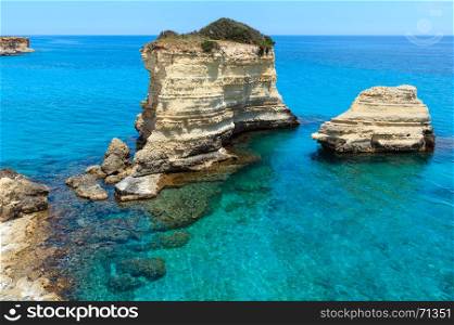 Picturesque seascape with cliffs and rocky stacks (faraglioni), at Torre Sant Andrea, Salento sea coast, Puglia, Italy.