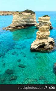 Picturesque seascape with cliffs and rocky stacks (faraglioni), at Torre Sant Andrea, Salento sea coast, Puglia, Italy.